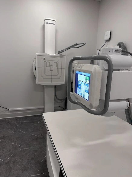 Physician standing by diagnostic equipment